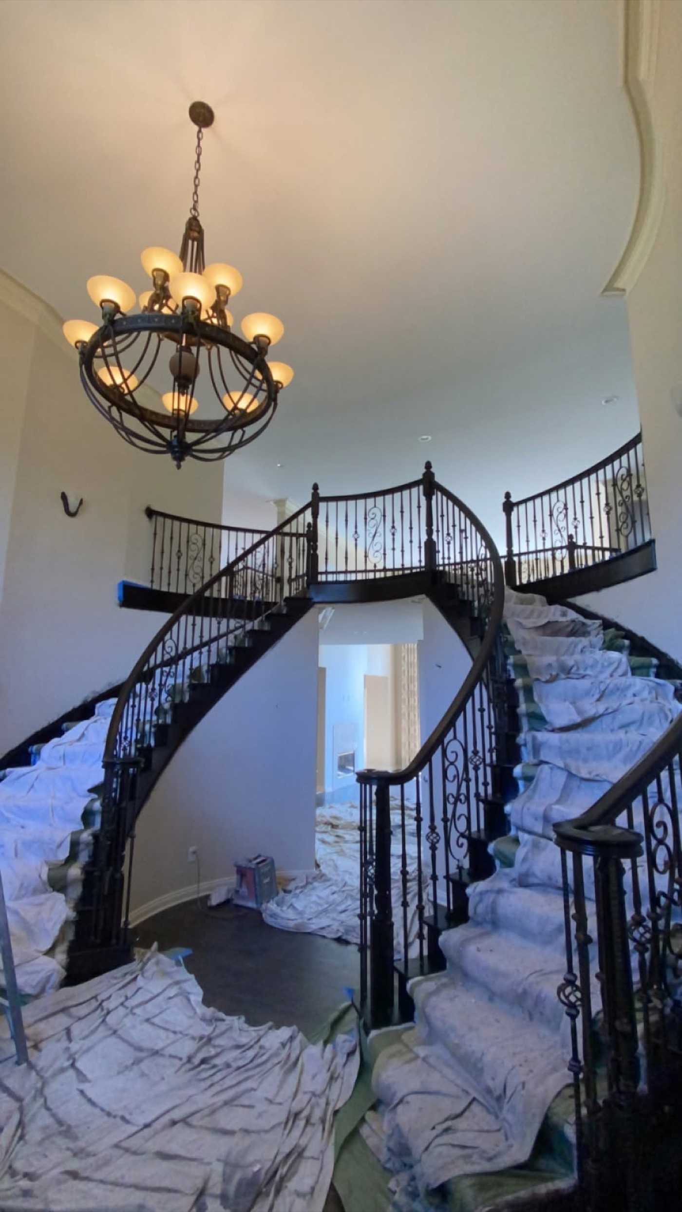 Interior foyer protected with drop cloths during painting preparation